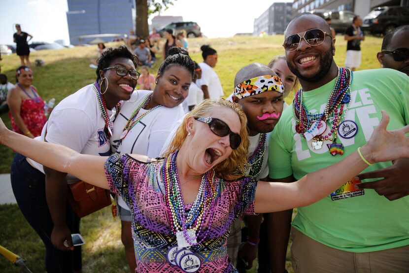 A group of spectators pose for a photo during the Alan Ross Texas Freedom Parade on Cedar...