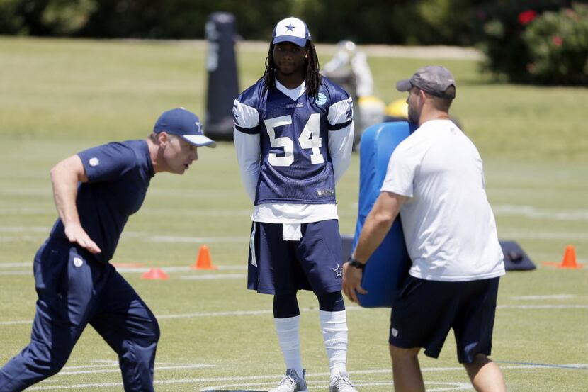 Dallas Cowboys linebacker Jaylon Smith (54) watches coaching staff demonstrate drills during...