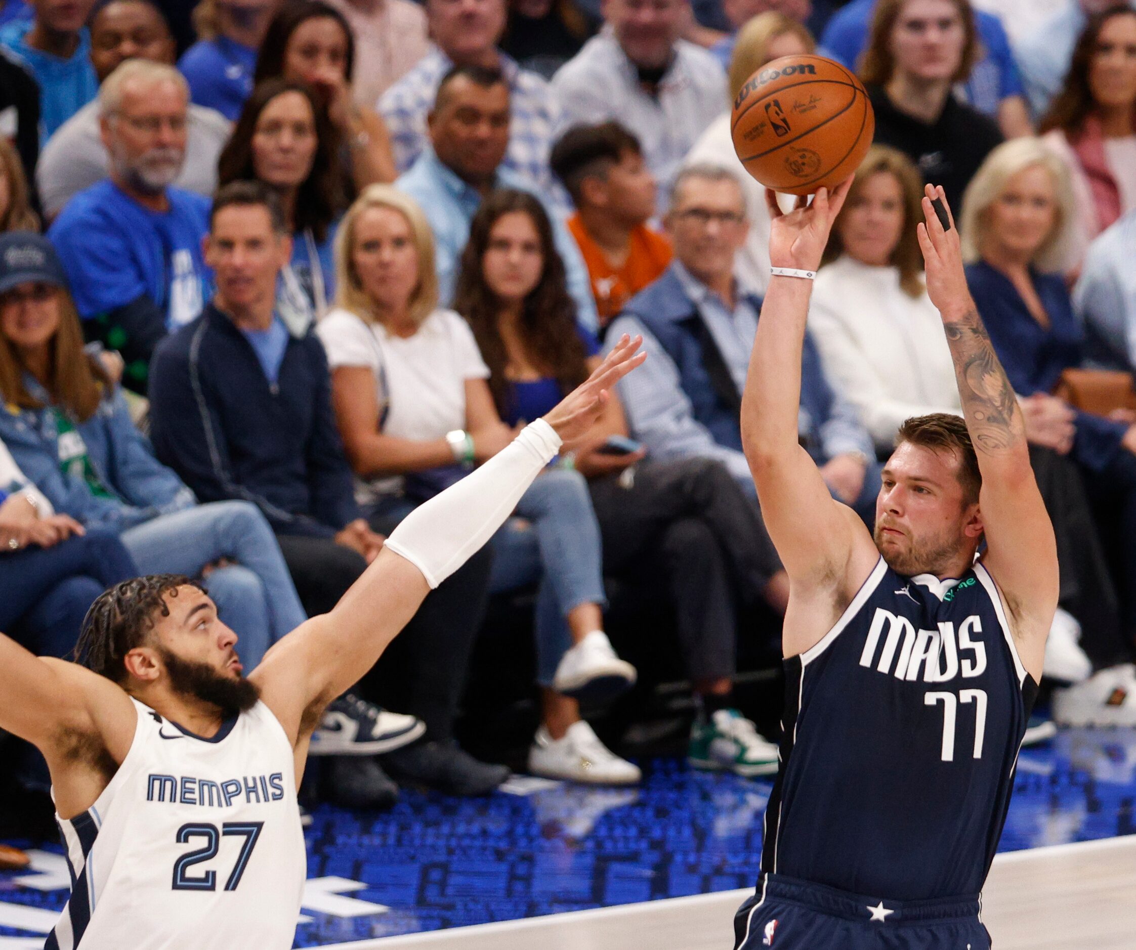 Dallas Mavericks guard Luka Doncic (77) shoots over Memphis Grizzlies guard David Roddy (27)...