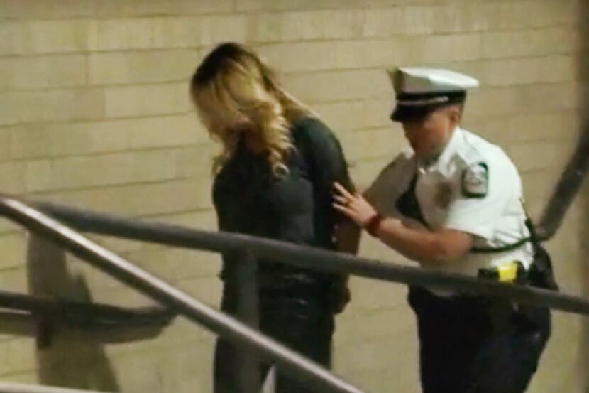 In this frame from video, porn actress Stormy Daniels is led into jail in Columbus, Ohio,...