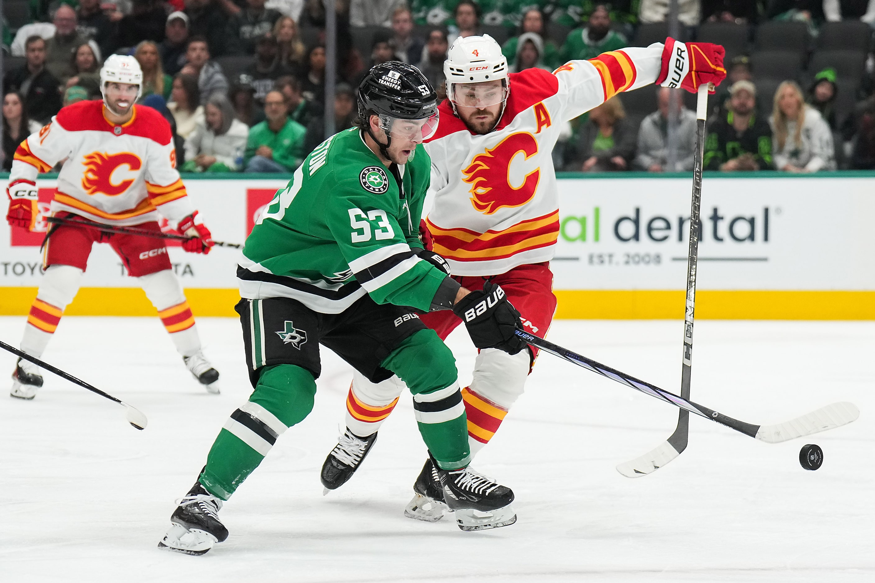 Dallas Stars center Wyatt Johnston (53) settle the puck in front of Calgary Flames...