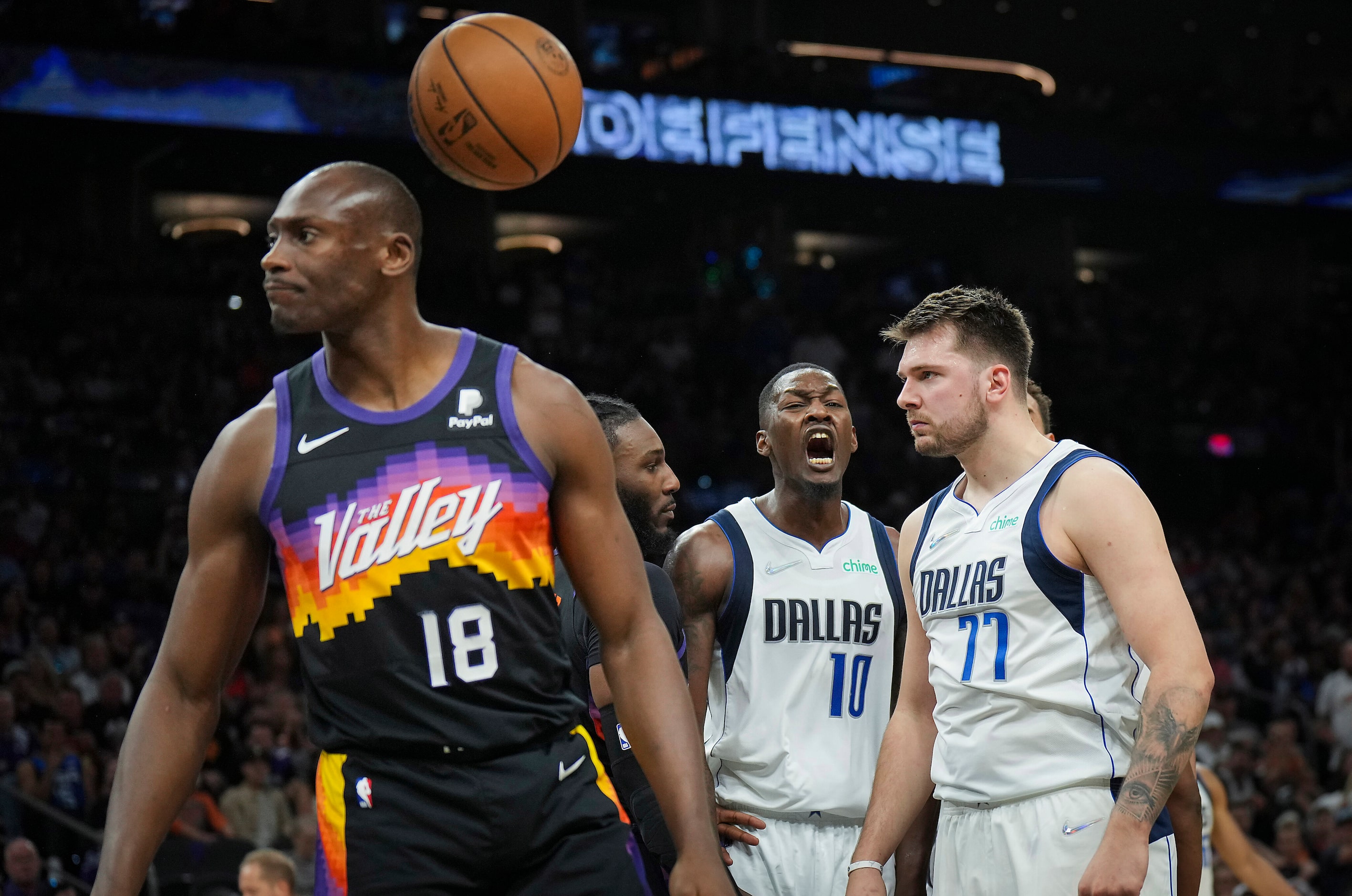 Dallas Mavericks guard Luka Doncic (77) celebrates with forward Dorian Finney-Smith (10)...