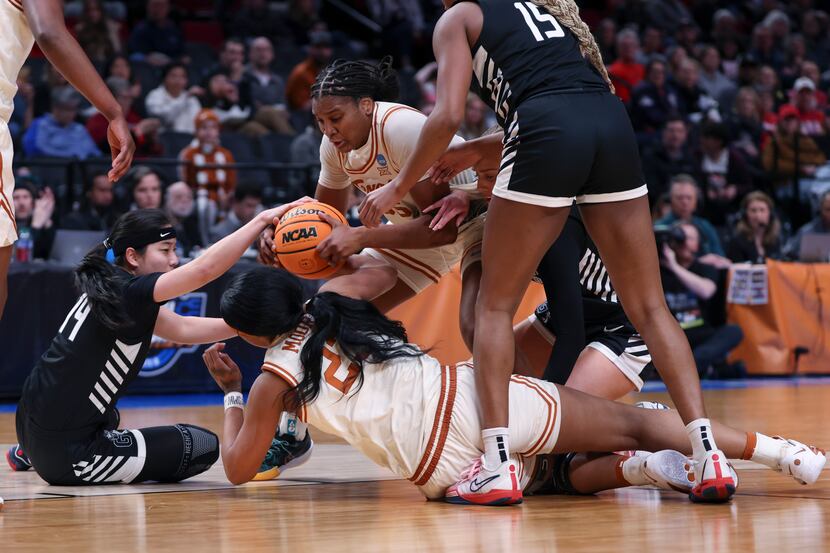 Texas forward Madison Booker, top center, goes for the ball against Gonzaga guard Kaylynne...