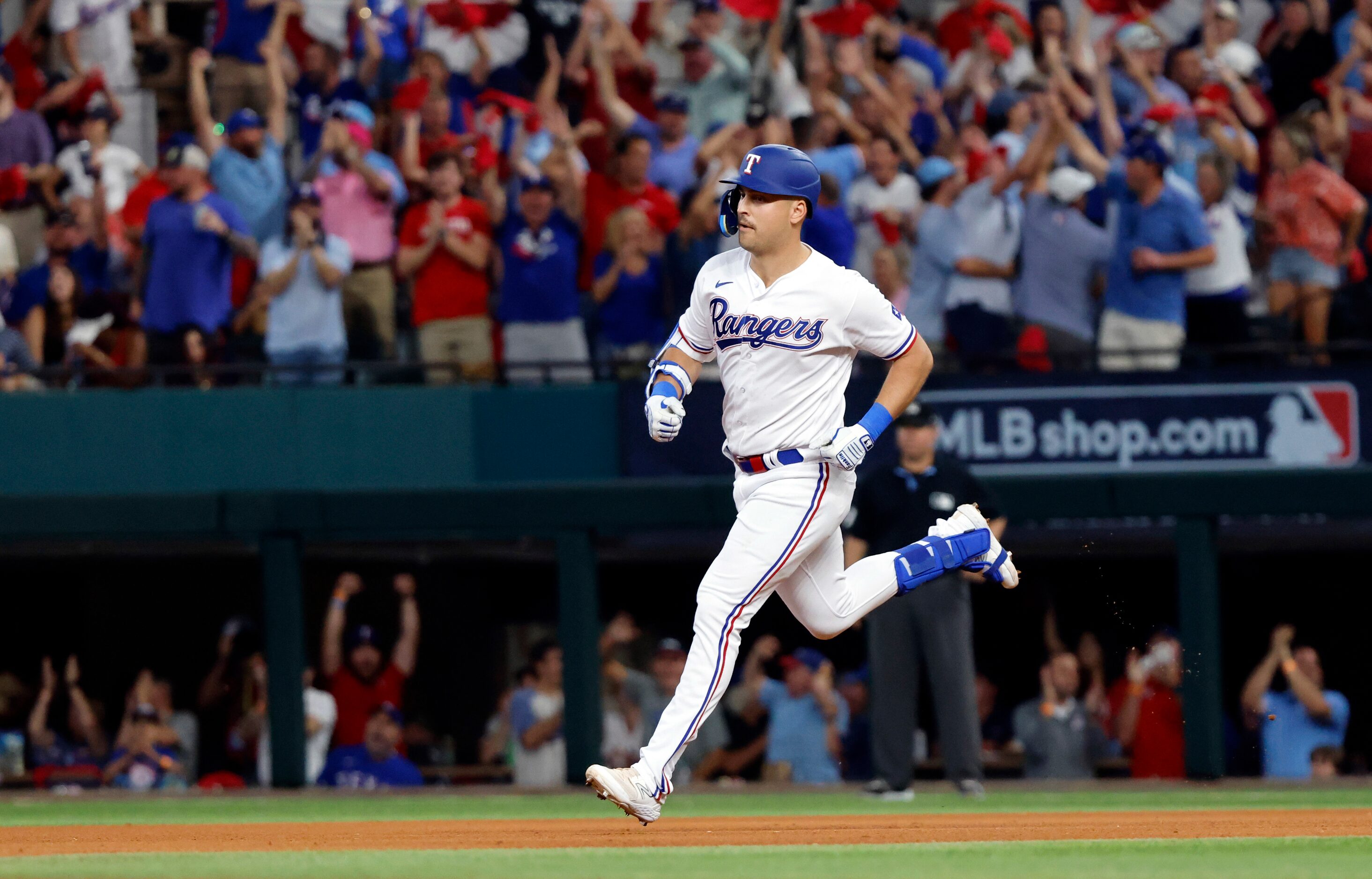 Texas Rangers batter Nathaniel Lowe rounds the bases on his fifth inning solo home run in...