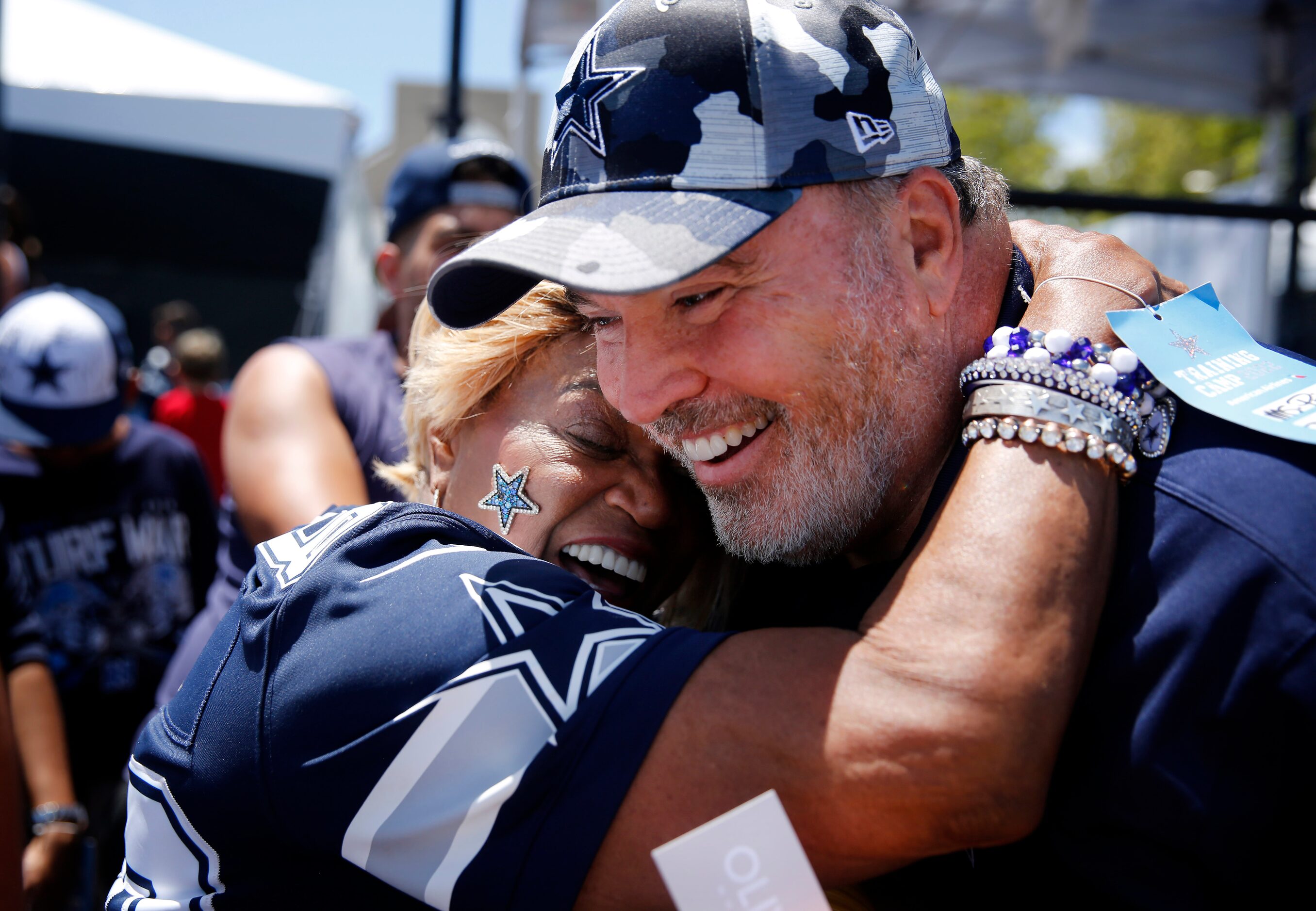 Dallas Cowboys head coach Mike McCarthy receives a hug from super fan Carolyn Price...