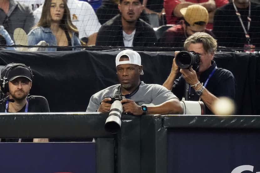 Former MLB player Ken Griffey Jr. is seen photographing Game 5 of the World Series between...