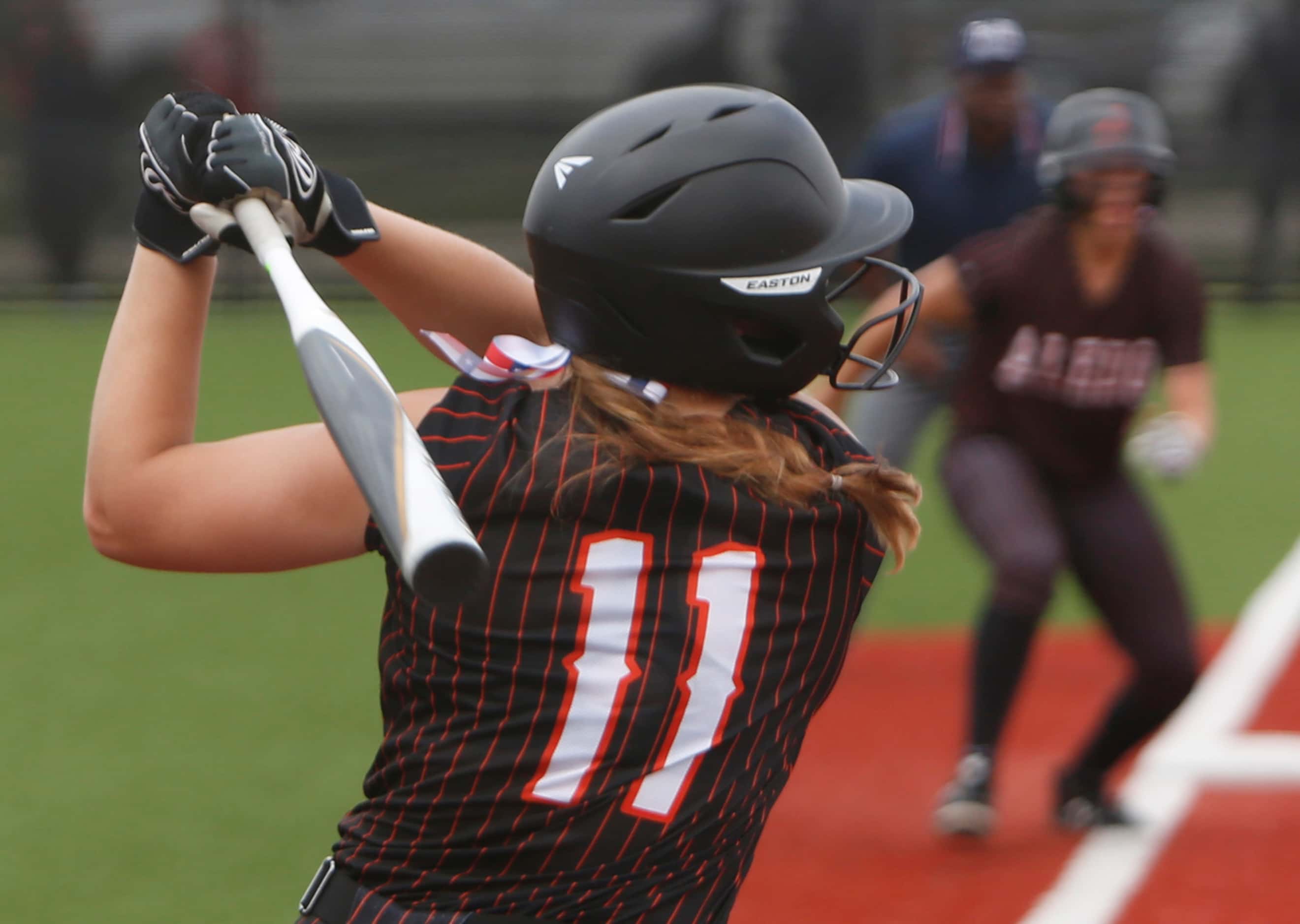 Aledo outfielder Marissa Powell (11) watches her long drive which left the park for a 3-run...