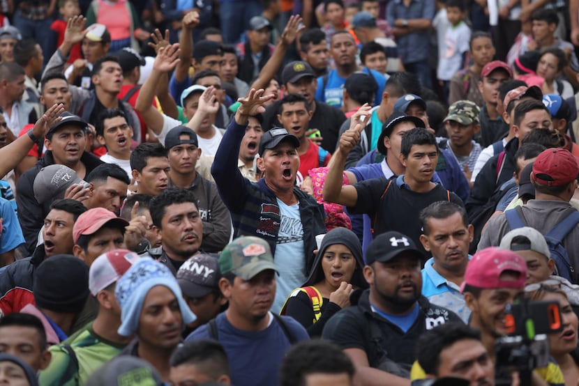 Members of an immigrant caravan sang the Honduran national anthem while gathering to discuss...