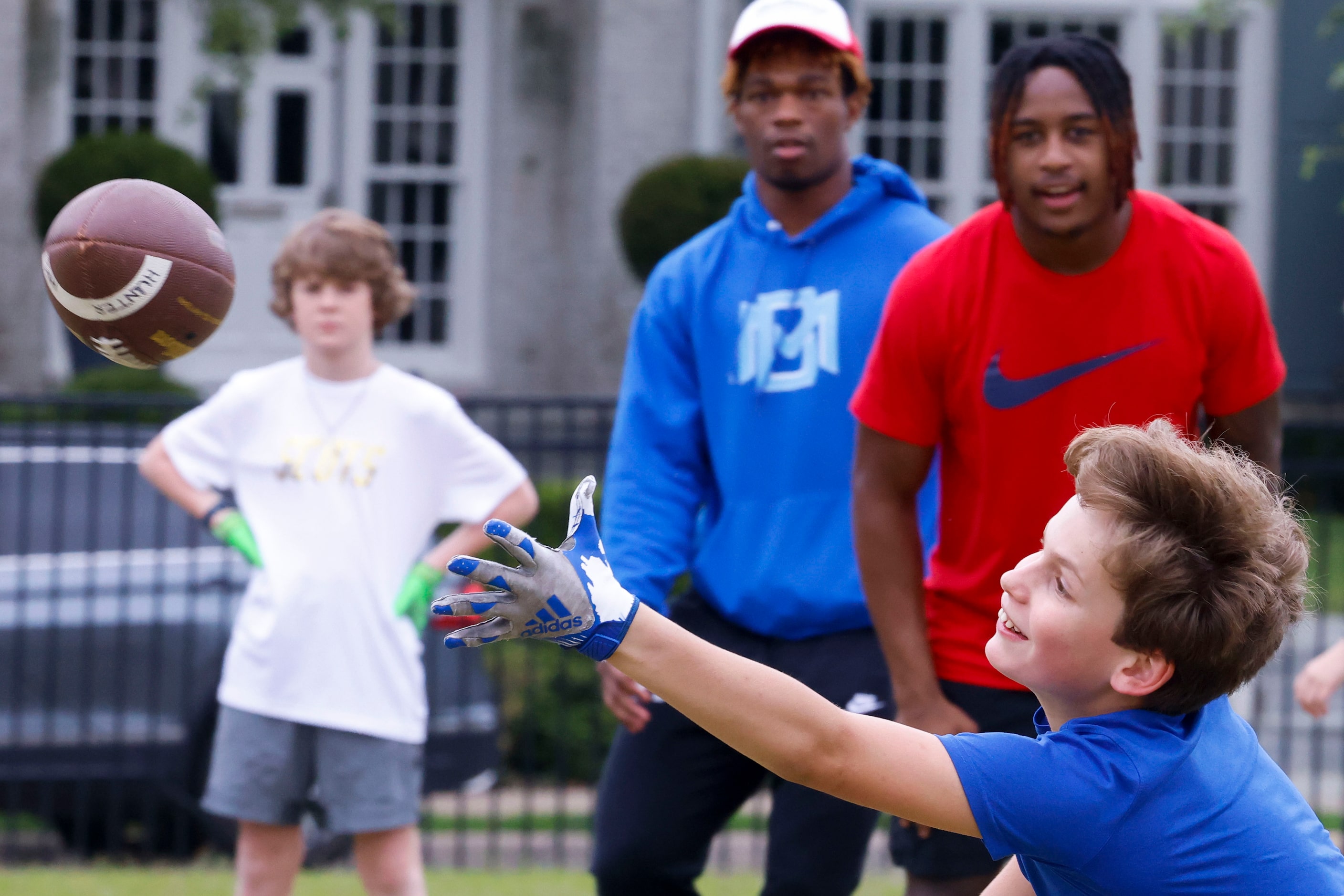 Grant Sacher (front) catchs a ball as SMU players Bryan Massey (left) and CJ Sanders watch...