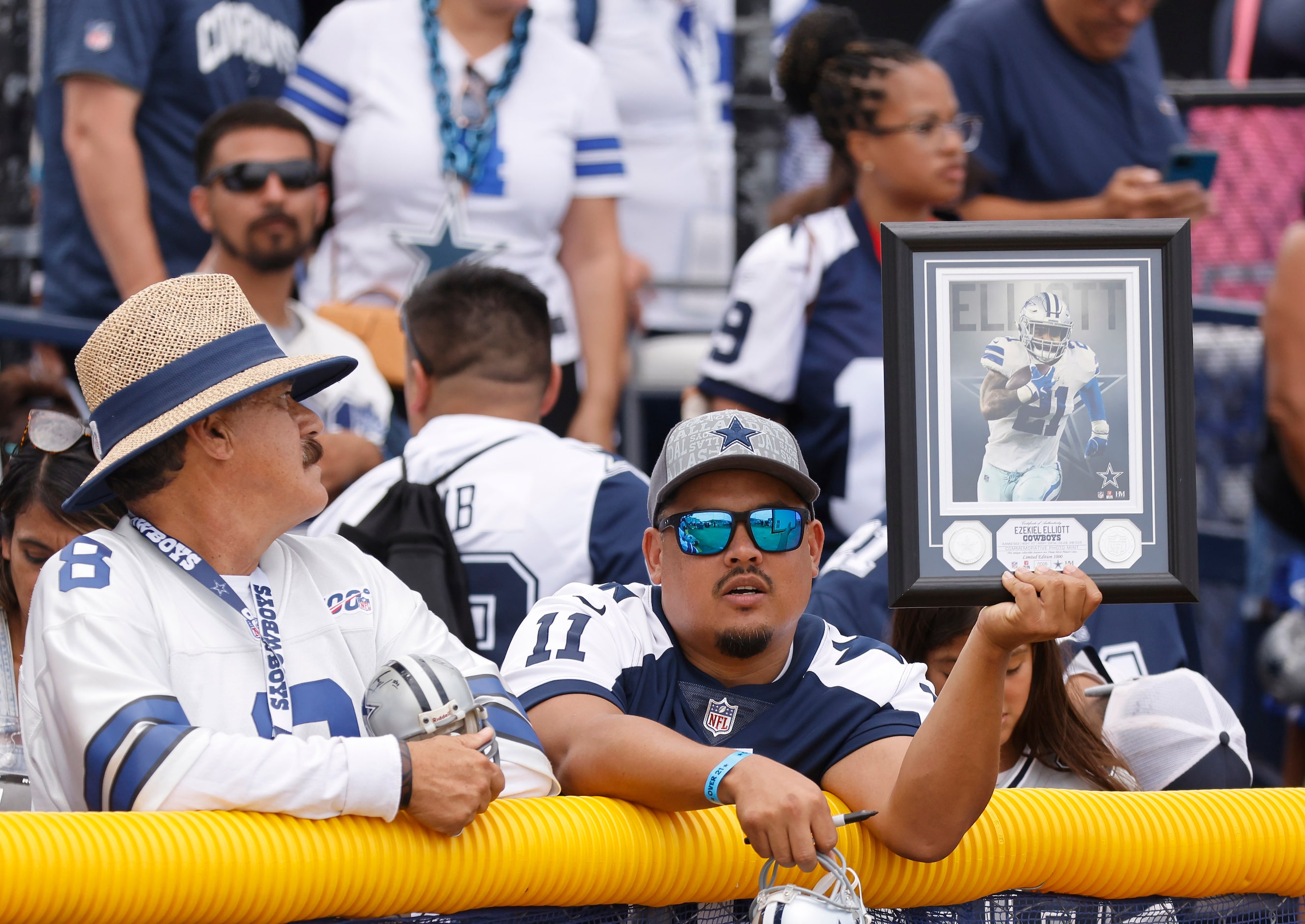 A Dallas Cowboys waits patiently for an autograph from running back Ezekiel Elliott...