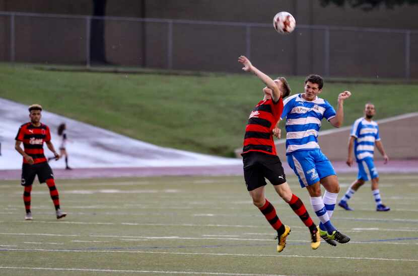 Sam Garza of the Denton Diablos takes an arm in the back from Zack Stavrou of the Vaqueros...