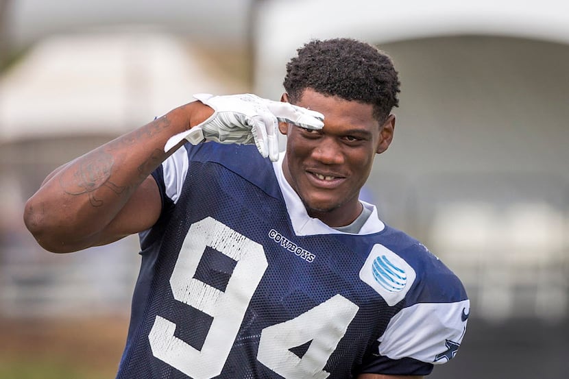 Dallas Cowboys defensive end Randy Gregory salutes the crowd following afternoon practice at...
