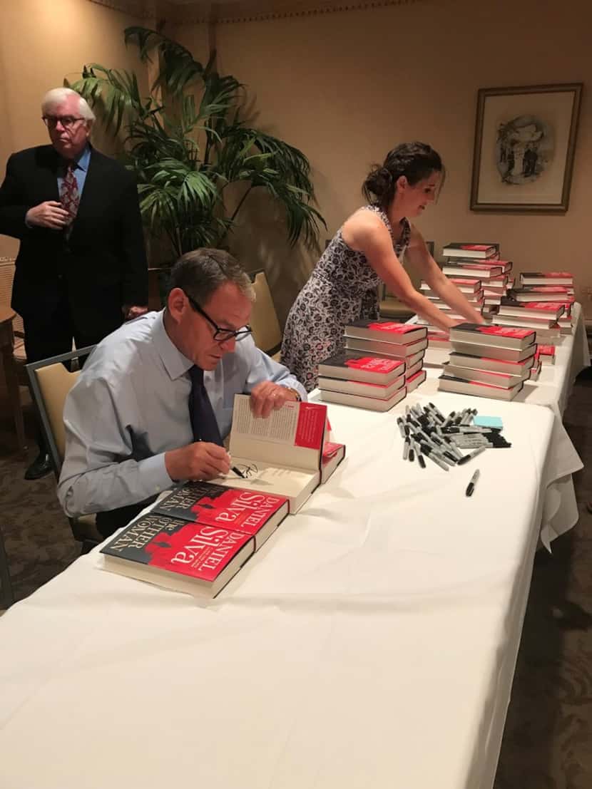 Best-selling author Daniel Silva signs more than 500 copies of his novel, The Other Woman,...