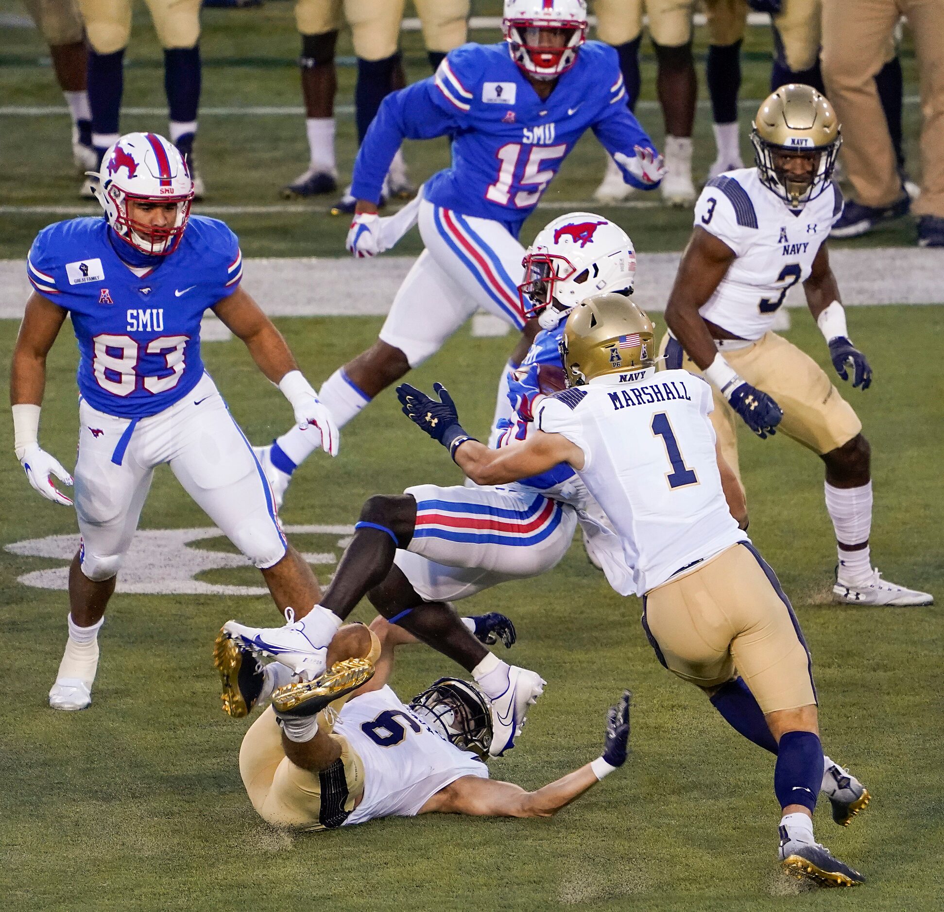 SMU running back Ulysses Bentley IV (26) is brought down by Navy defensive back Mitchell...