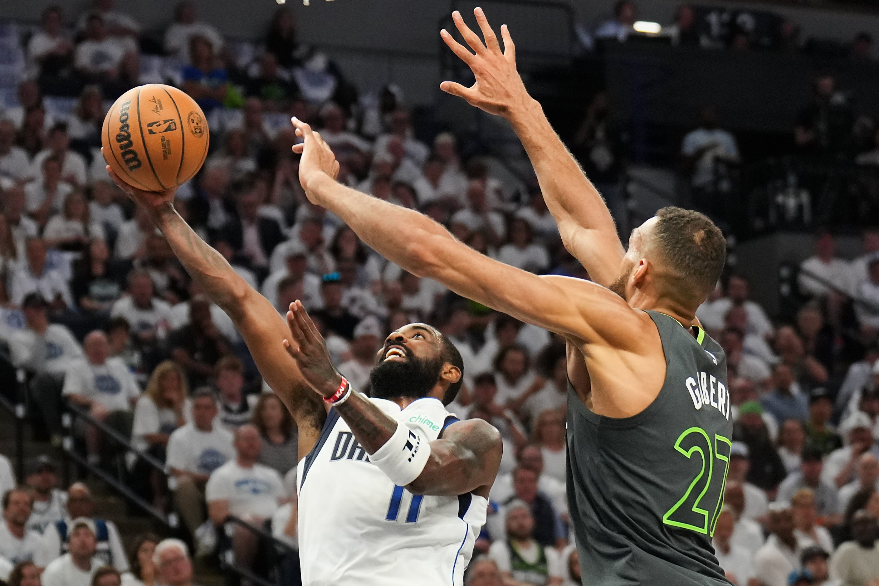 Dallas Mavericks guard Kyrie Irving (11) scores past Minnesota Timberwolves center Rudy...