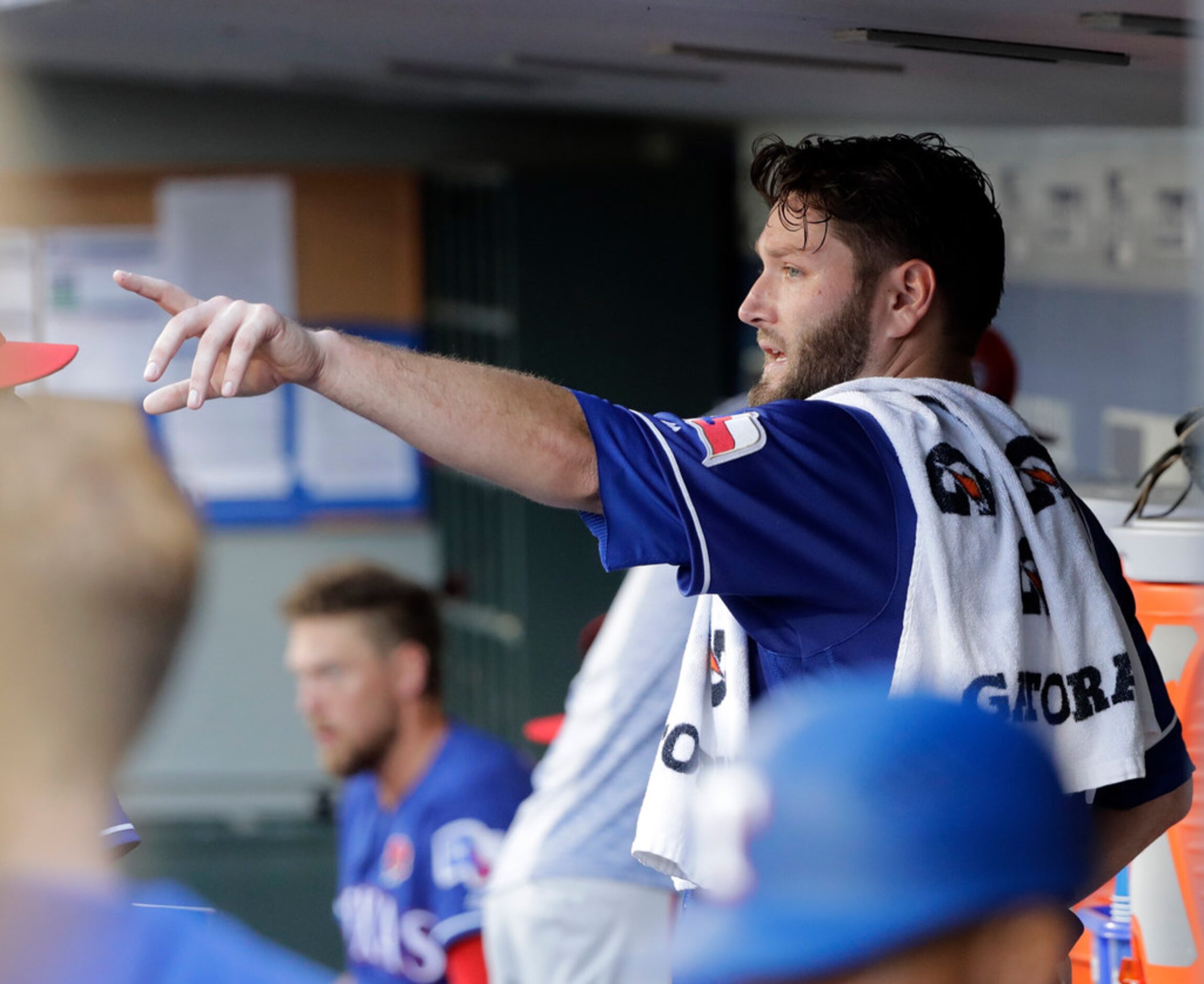 Texas Rangers starting pitcher Lance Lynn gestures from the dugout during the third inning...