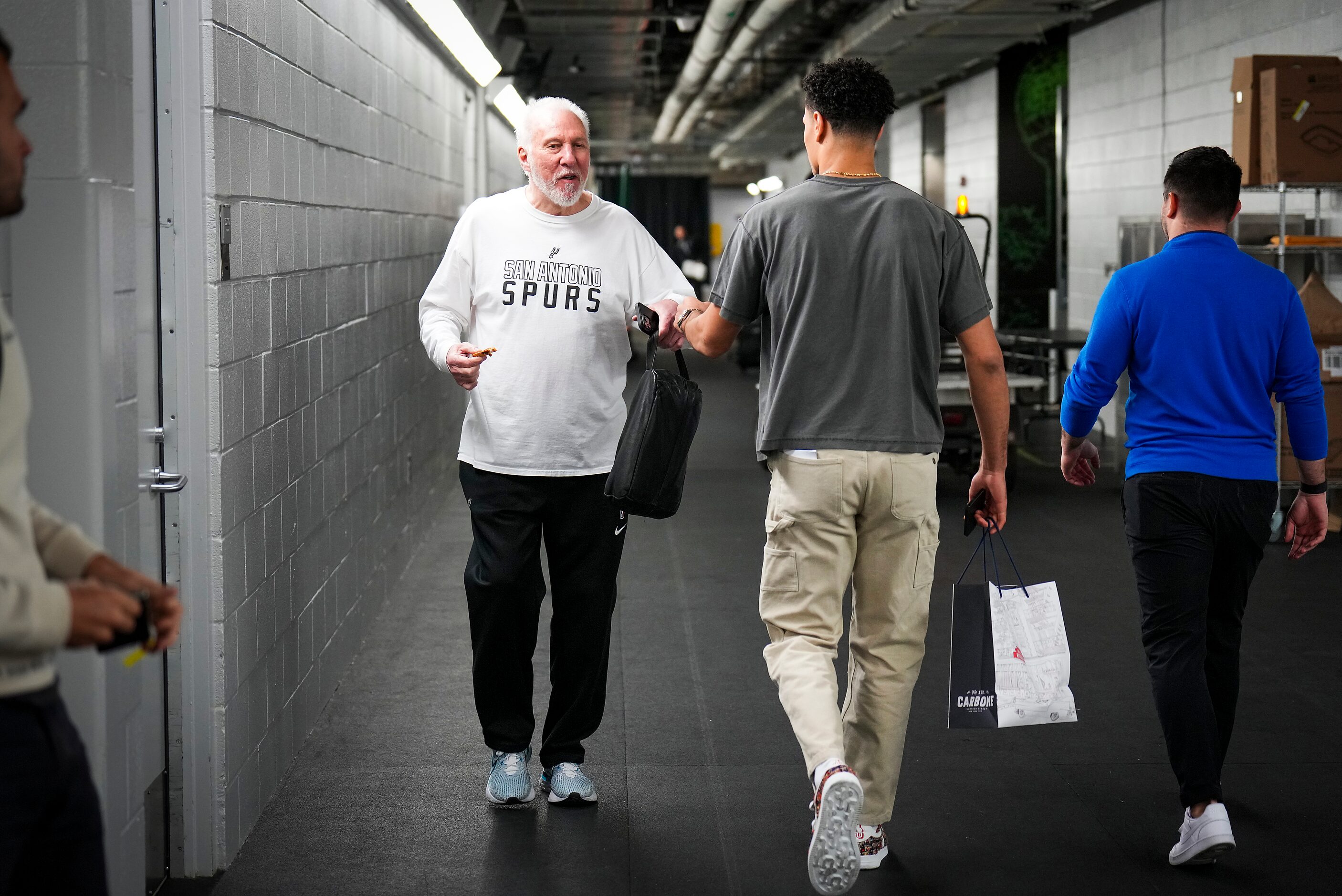 San Antonio Spurs head coach Gregg Popovich fist bumps Dallas Mavericks guard Josh Green as...