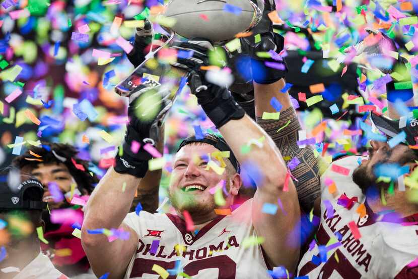 Oklahoma Sooners offensive lineman Ben Powers (72) holds up of the Big 12 Championship...