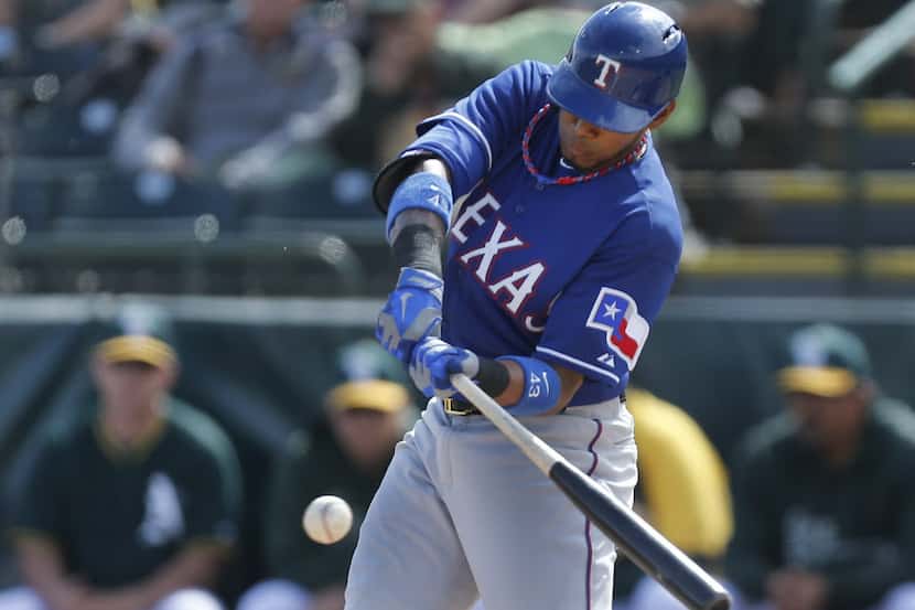 Texas Engel Beltre makes contact for a base hit in the first inning during the Texas Rangers...