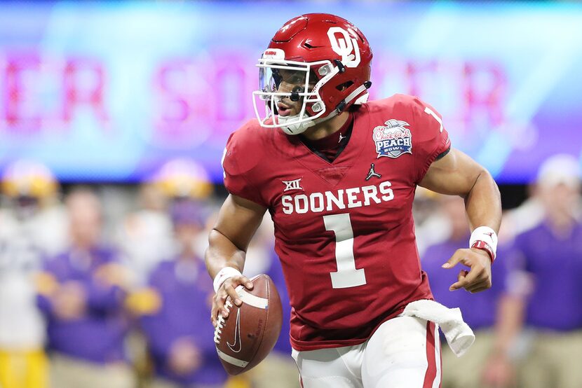 ATLANTA, GEORGIA - DECEMBER 28: Quarterback Jalen Hurts #1 of the Oklahoma Sooners carries...