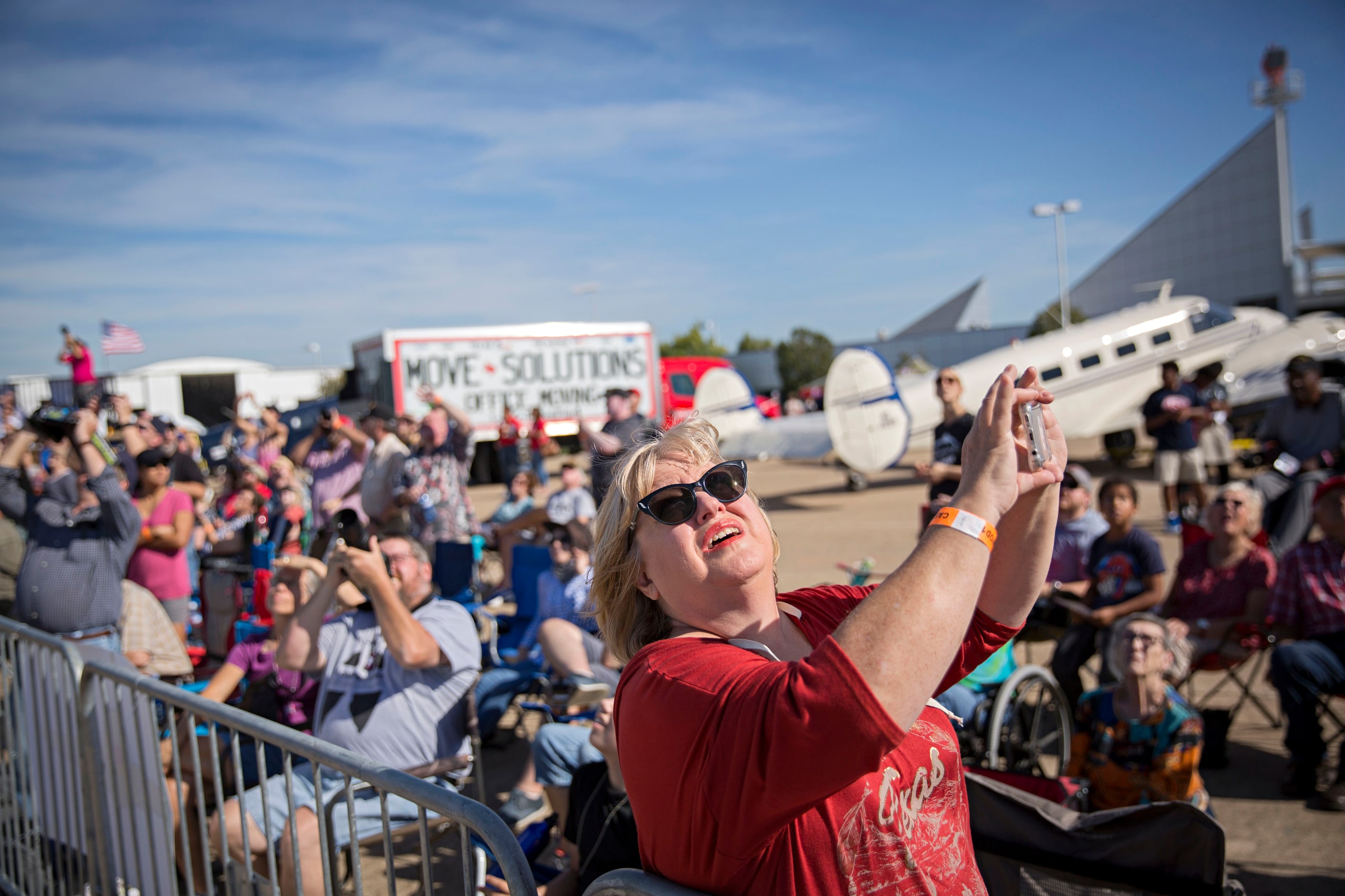 Lynda Cole of Henderson, Texas watches planes take off during the Commemorative Air Force...