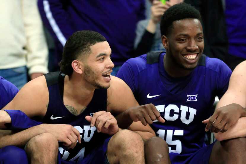 TCU guard Kenrich Williams, left, and forward JD Miller (15) smile on the bench during...