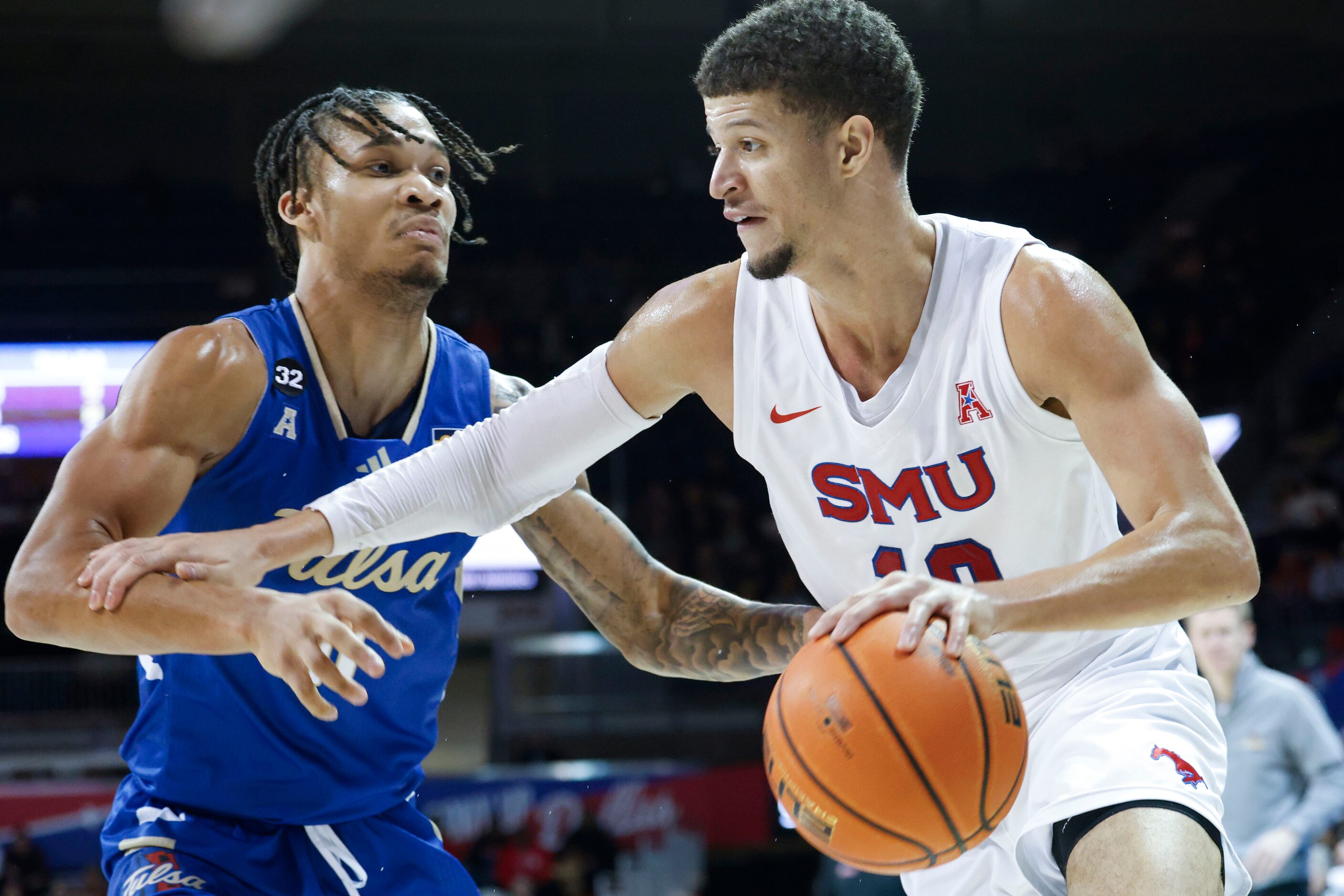 Southern Methodist forward Samuell Williamson (right) dribbles past Tulsa guard Isaiah...