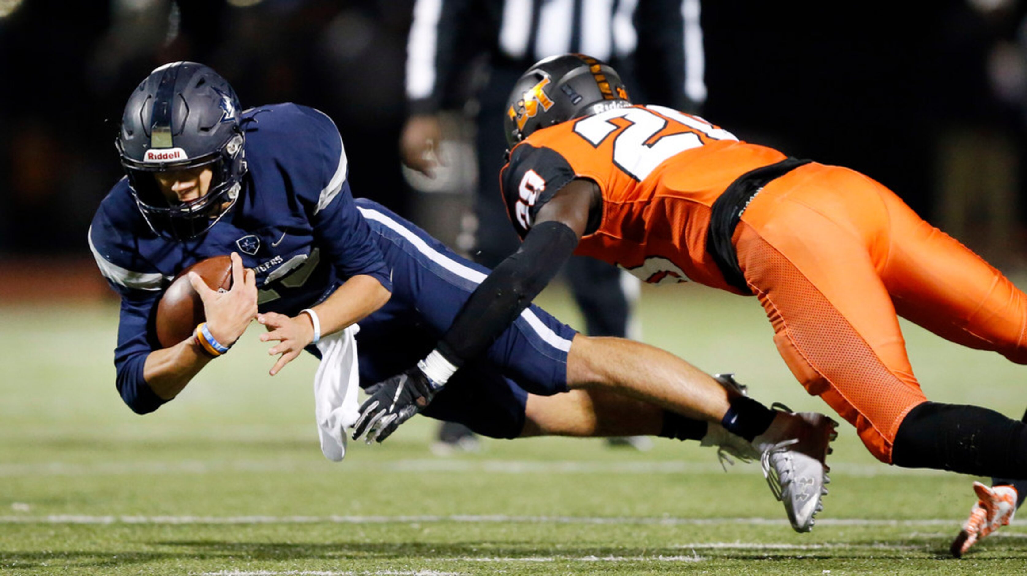 Frisco Lone Star quarterback Garrett Rangel (13) dives for extra yards against Lancaster...