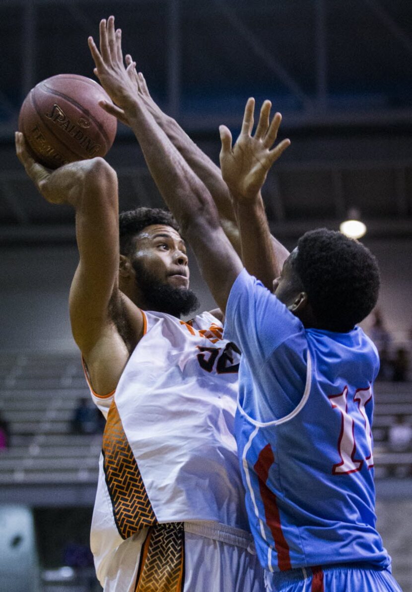 Lancaster's Nate Morris (32) goes up for a shot over Skyline's Terrion Randolph (11) during...