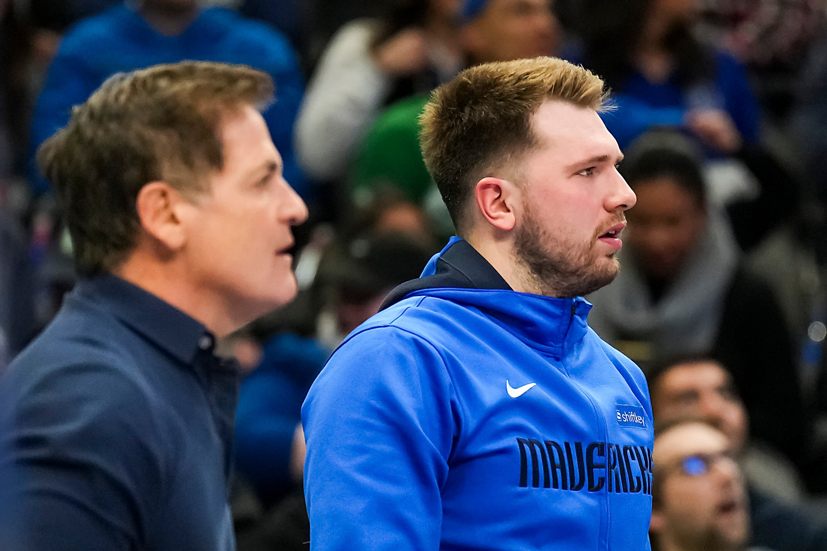 Dallas Mavericks guard Luka Doncic watches from the bench with owner Mark Cuban during the...