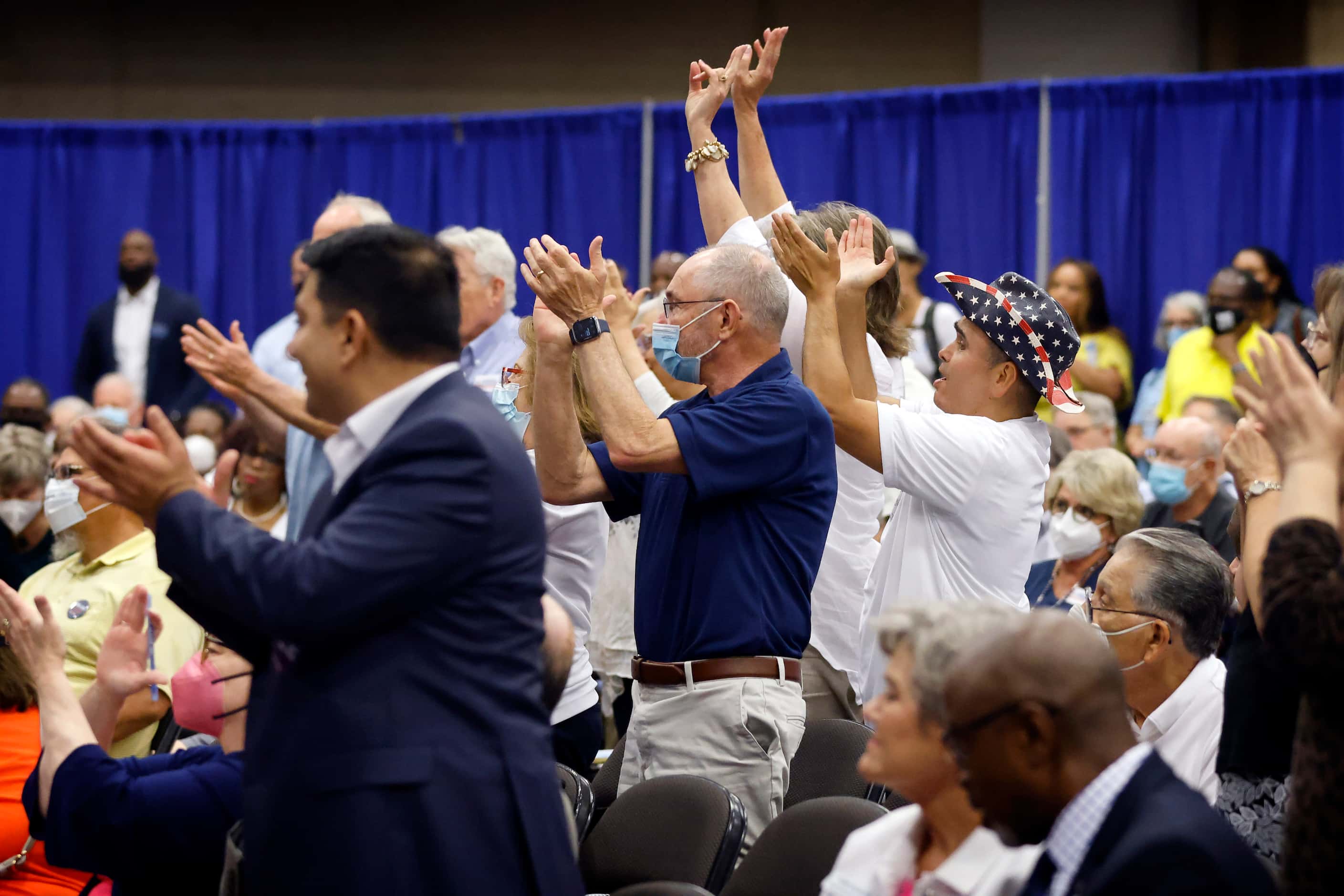 Delegates stand and applaud during the SDEC (State Democratic Executive Committee) meeting...