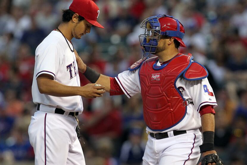 Texas Rangers starting pitcher Yu Darvish (11) talks with Texas Rangers catcher Geovany Soto...