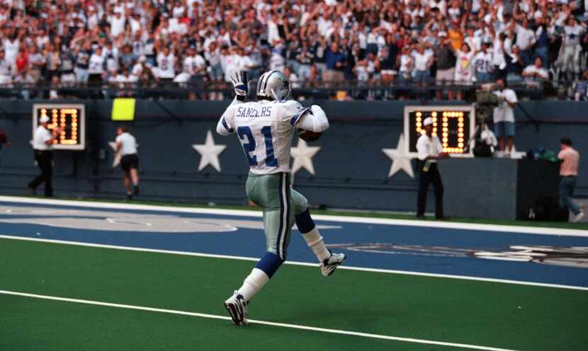 FILE - Cowboys cornerback Deion Sanders (21) celebrates on his way to the end zone after...