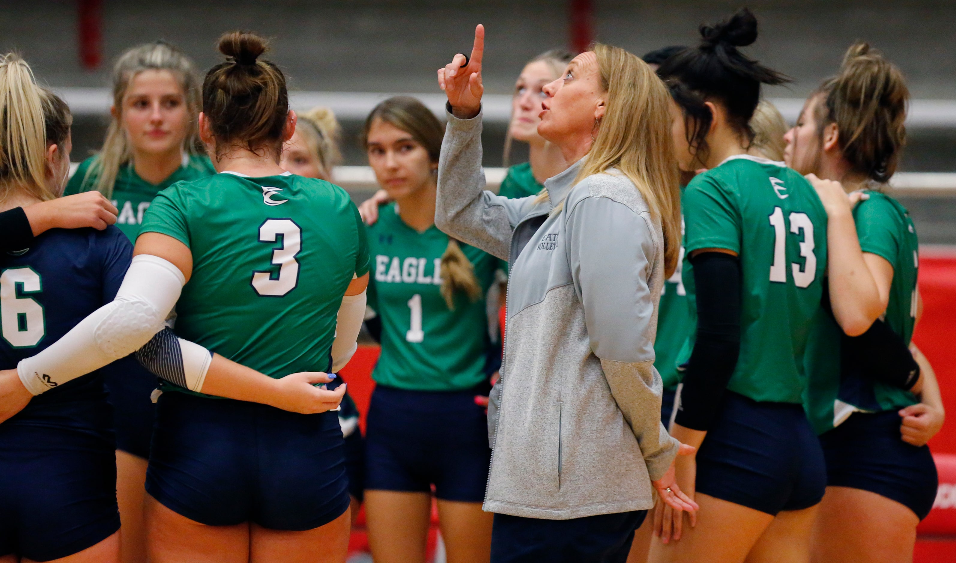 Eaton head coach Diane Wilson talks to her team during a time out in game one as Flower...