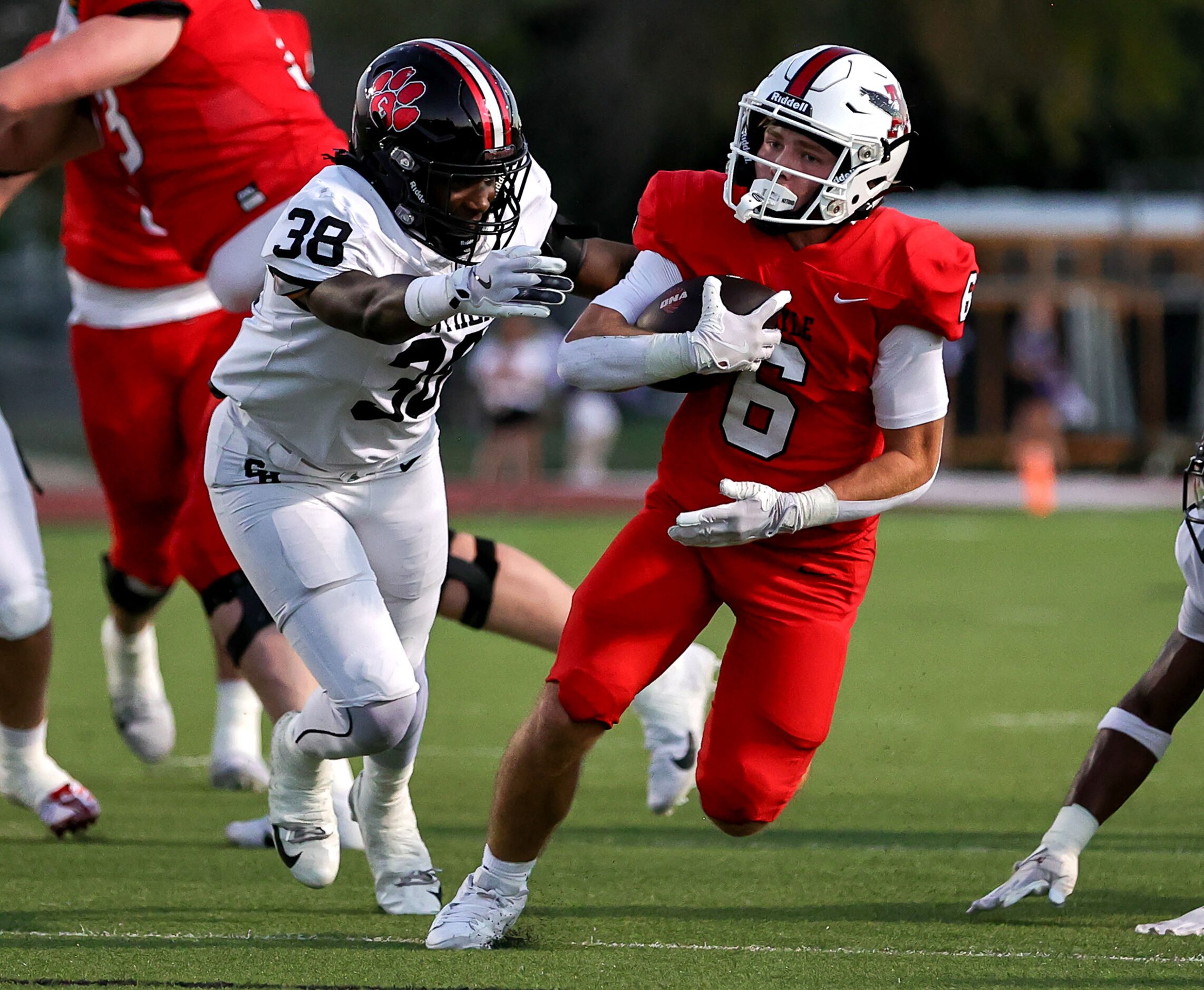 Argyle running back Watson Bell (6) tries to get past Colleyville Heritage linebacker Darian...