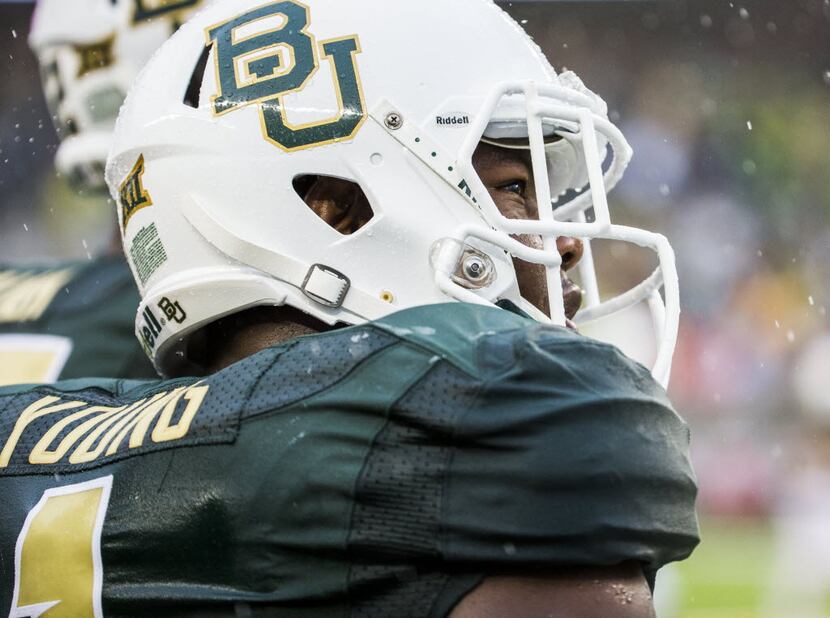 Baylor Bears linebacker Taylor Young (1) looks at the scoreboard through the rain during the...