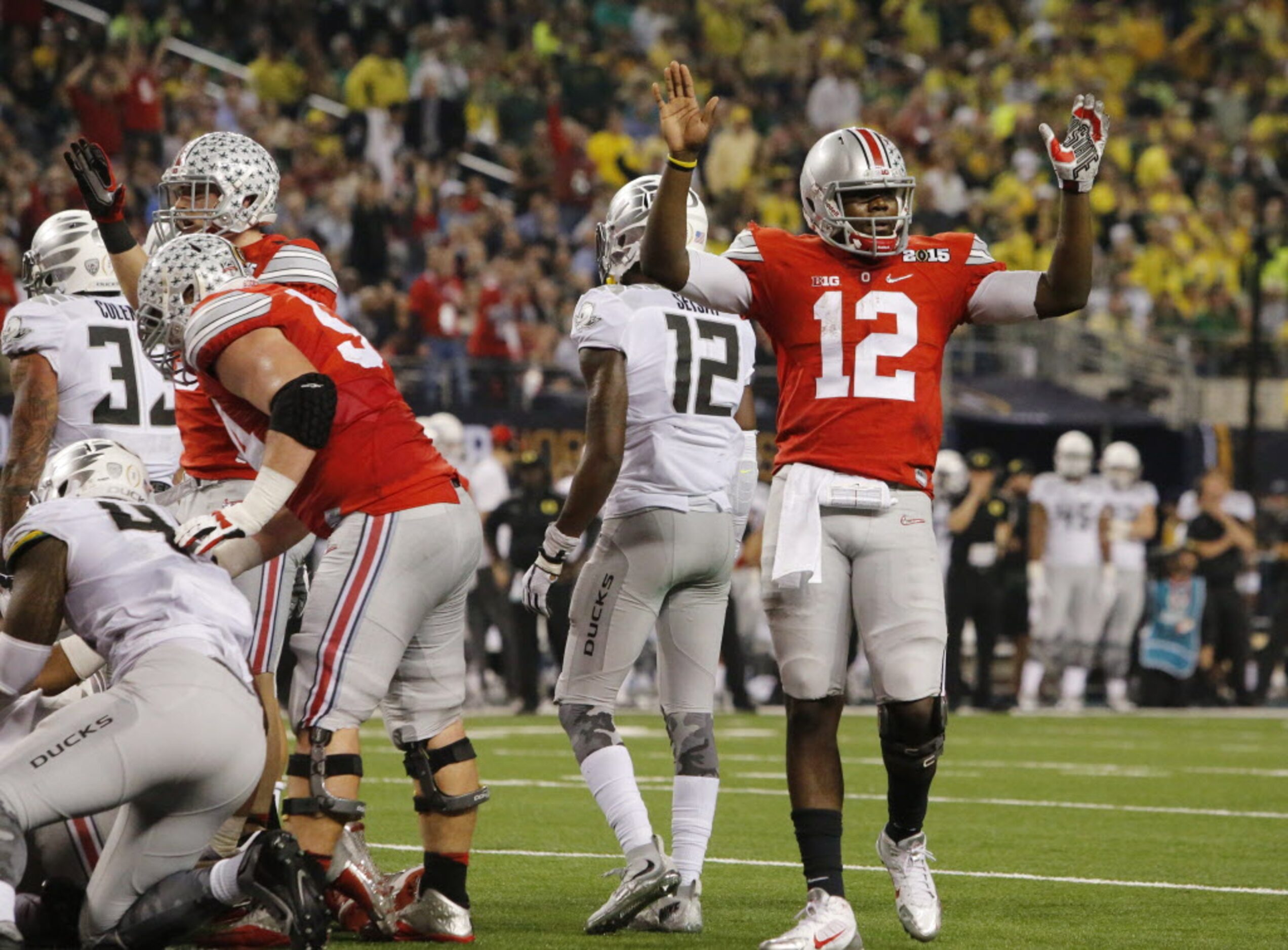 Ohio State Buckeyes quarterback Cardale Jones (12) celebrates a touchdown by running back...