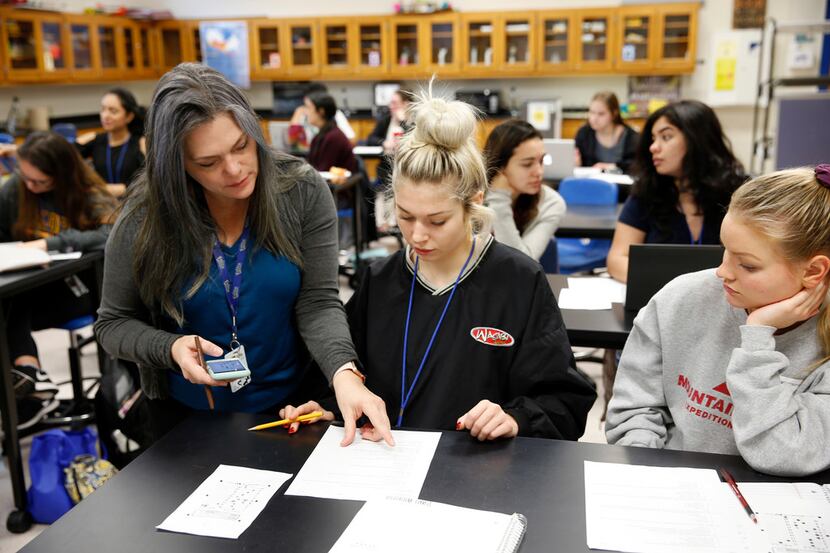 AP Environmental Science teacher Tina Littlejohn goes over a quiz question with her students...
