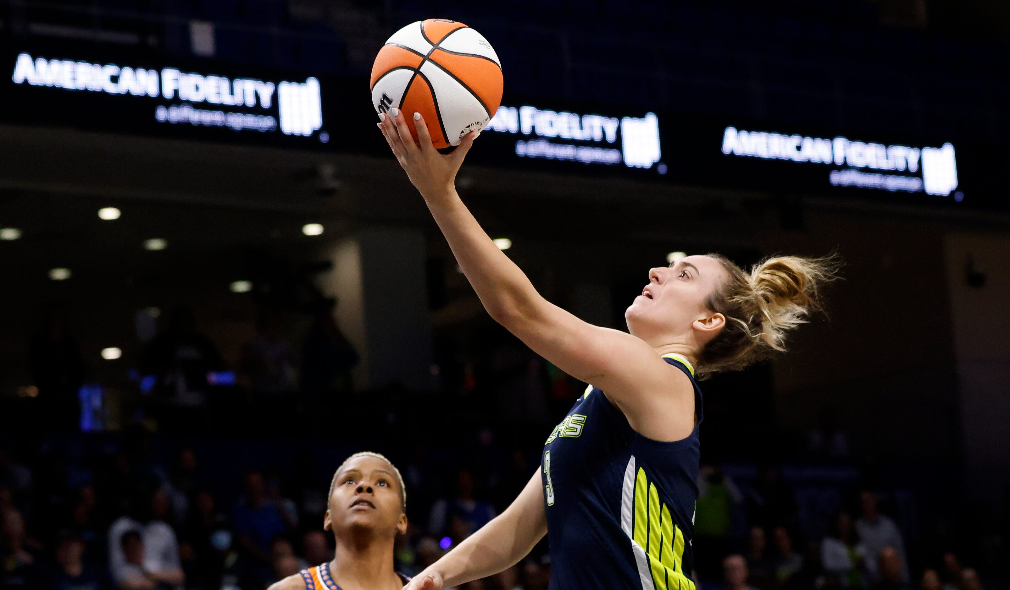 Dallas Wings guard Marina Mabrey (3) lays up a shot over Connecticut Sun guard Courtney...