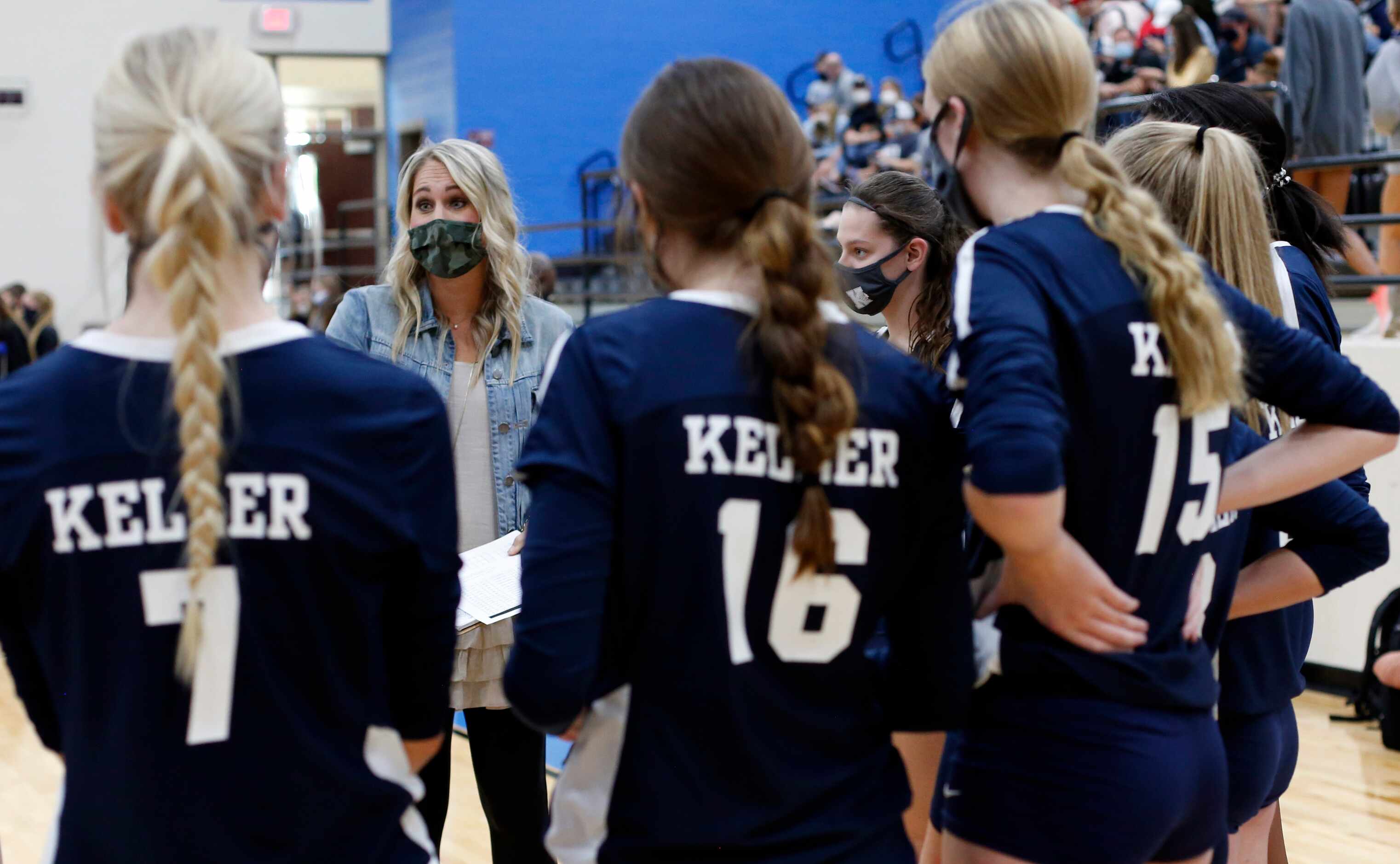 Keller head coach Lauren Rao talks game strategy with her team during a timeout following...