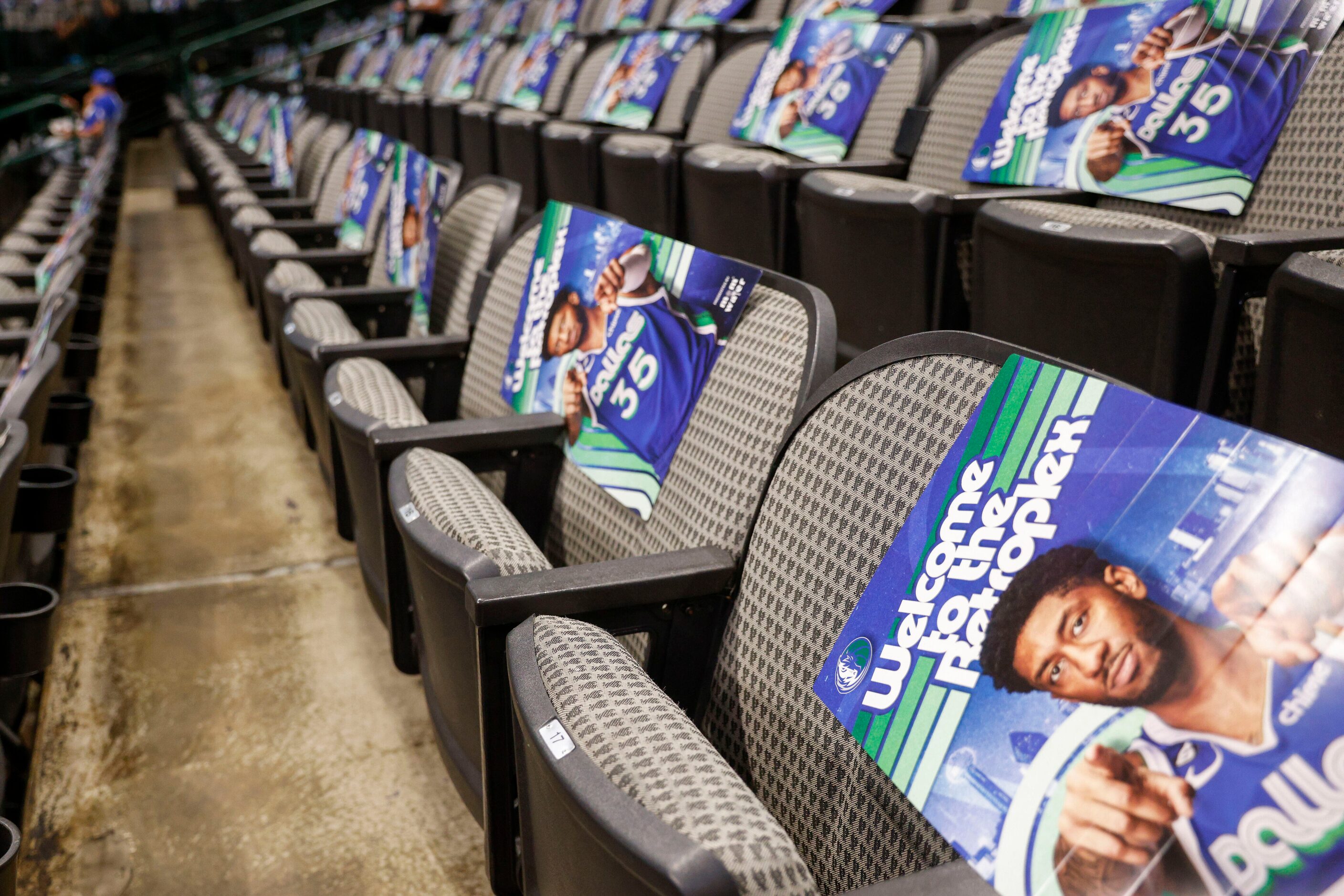 Posters of Dallas Mavericks center Christian Wood (35) wearing a City Edition jersey rest on...