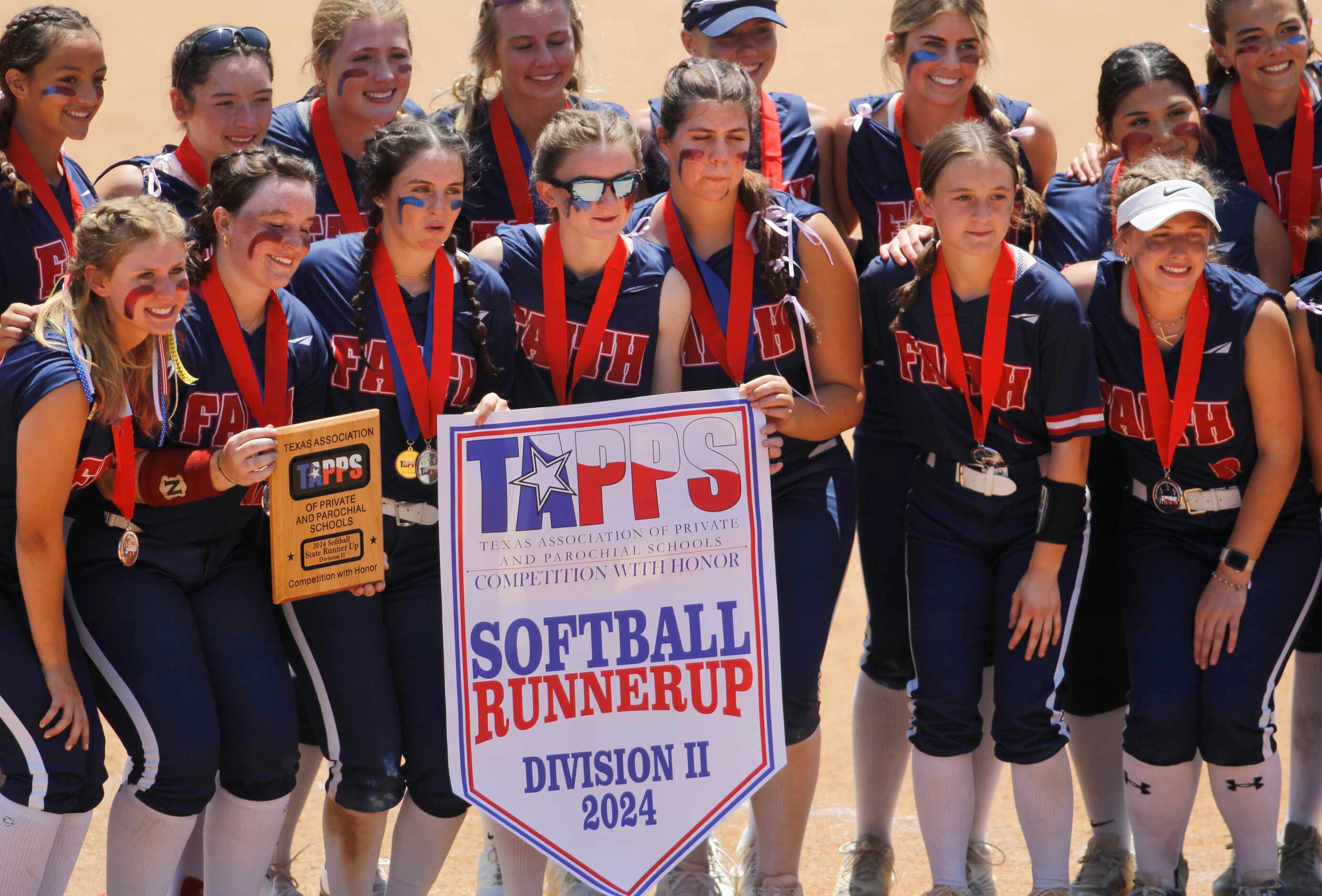 Grapevine Faith Christian players pose with their runner-up banner and plaque following...