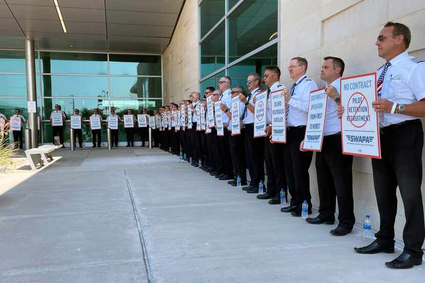 Southwest Airlines pilots picket outside the terminal at Dallas Love Field on June 21, 2022,...