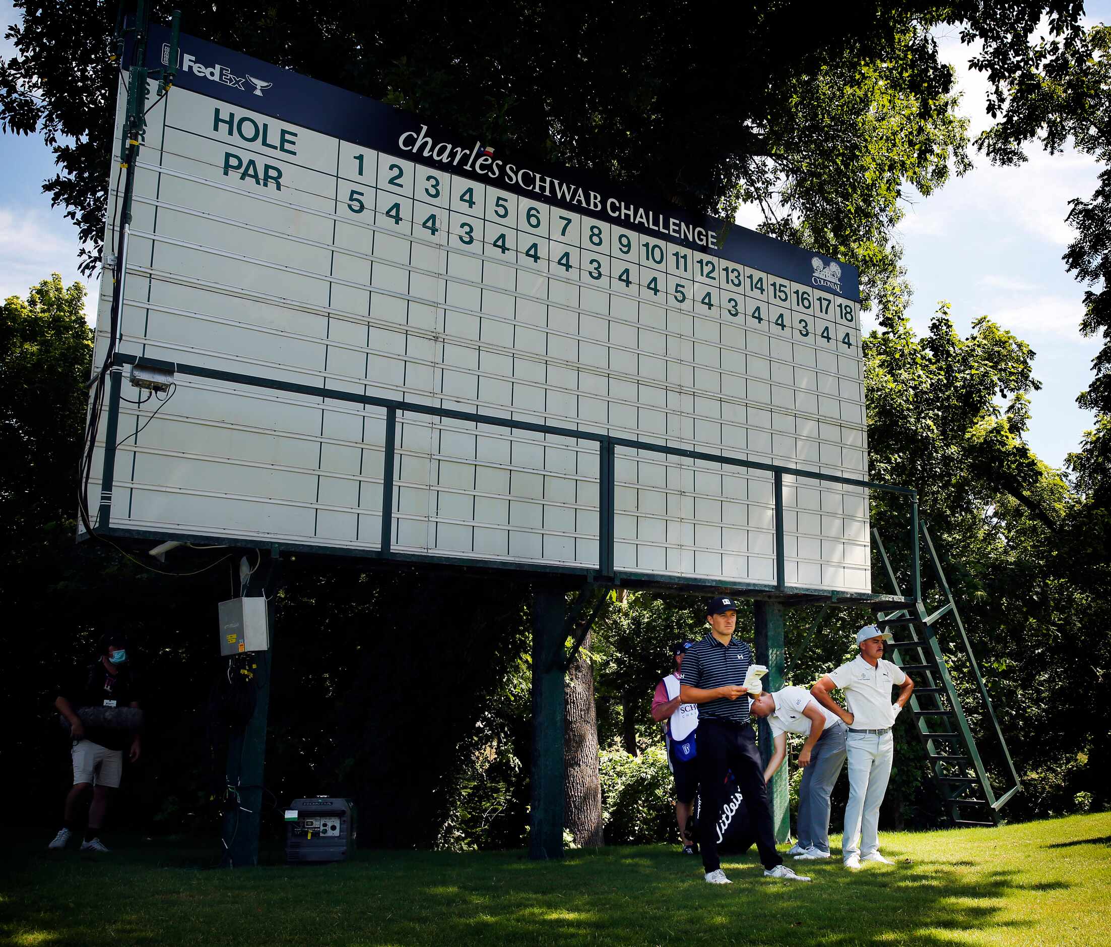 PGA Tour golfers Jordan Spieth (left) and Rickie Fowler takes relief from the sun before an...