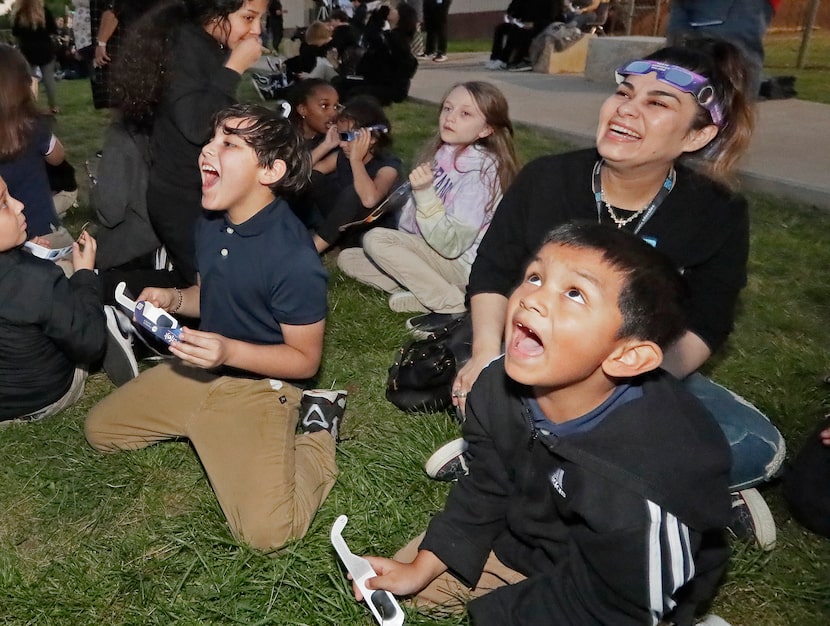 Dallas residents Javier Baesa (left), 8, his mother Leslie (upper right) and Matthew Vasquez...