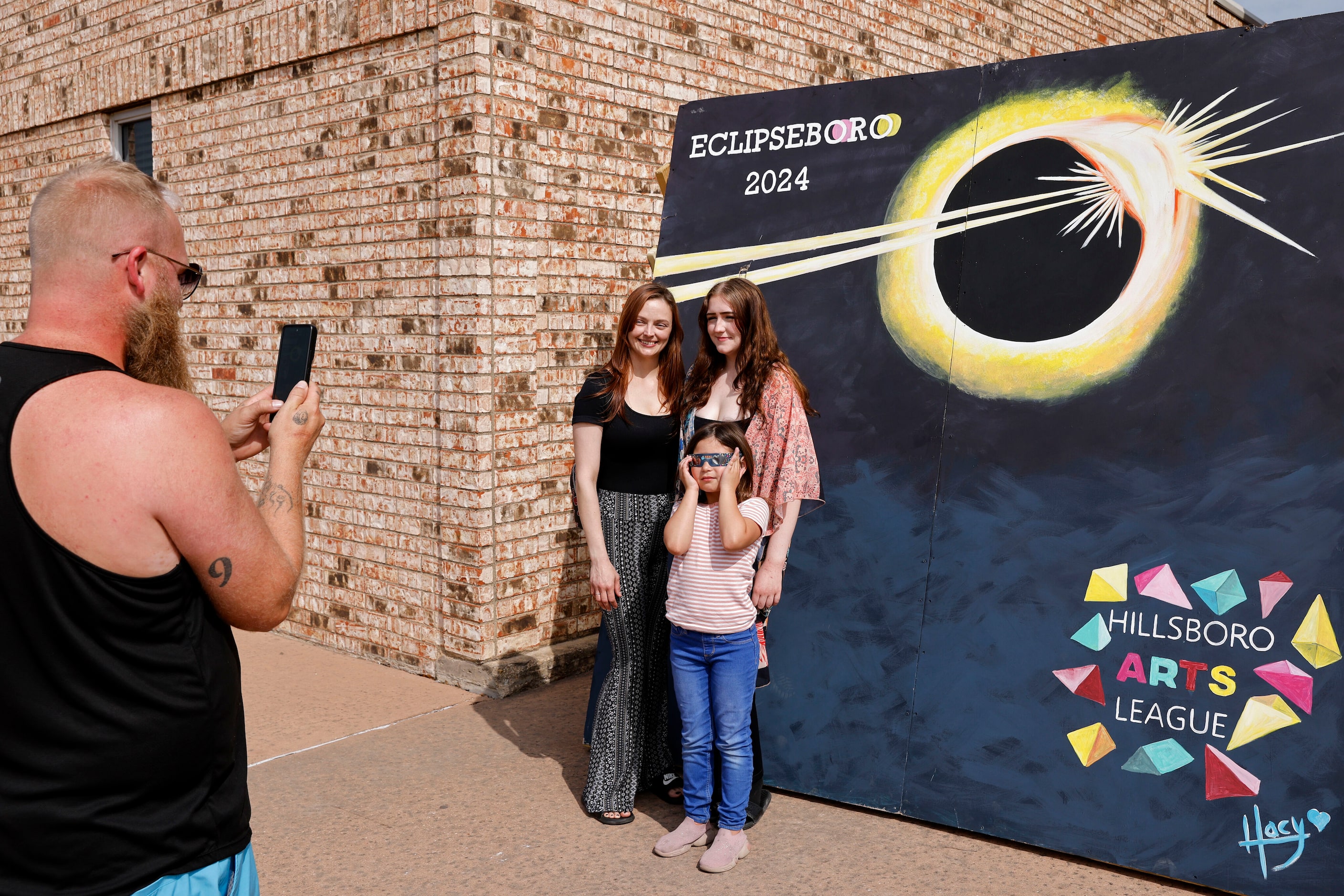 Justin Ripple (left) takes a photo of Britney Lex of Freeport, Texas, Neviah Johnstone, 17,...