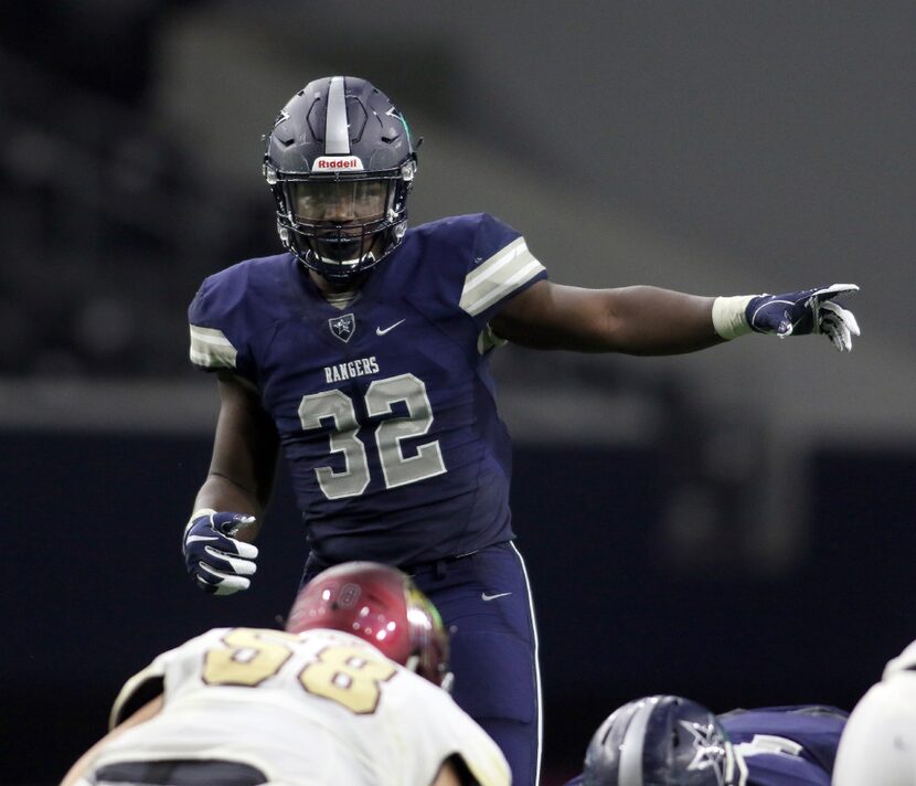 Frisco Lone Star linebacker Nicholas Bolton (32) directs the Rangers defense during the...