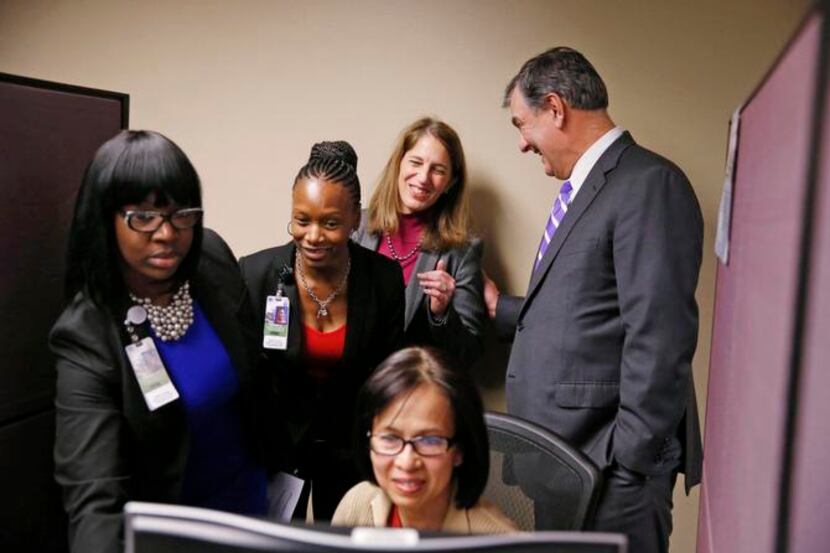 
Dallas Mayor Mike Rawlings talked to HHS Secretary Sylvia Burwell (back center) Monday...