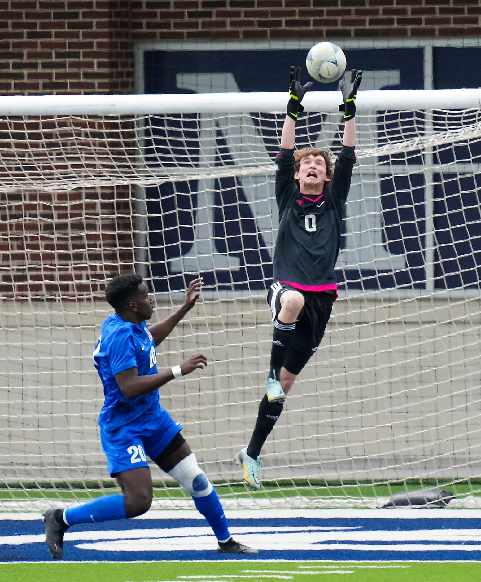 Lake Highlands goalkeeper Noah Smith (0) reaches for the ball over Allen forward Osiramah...