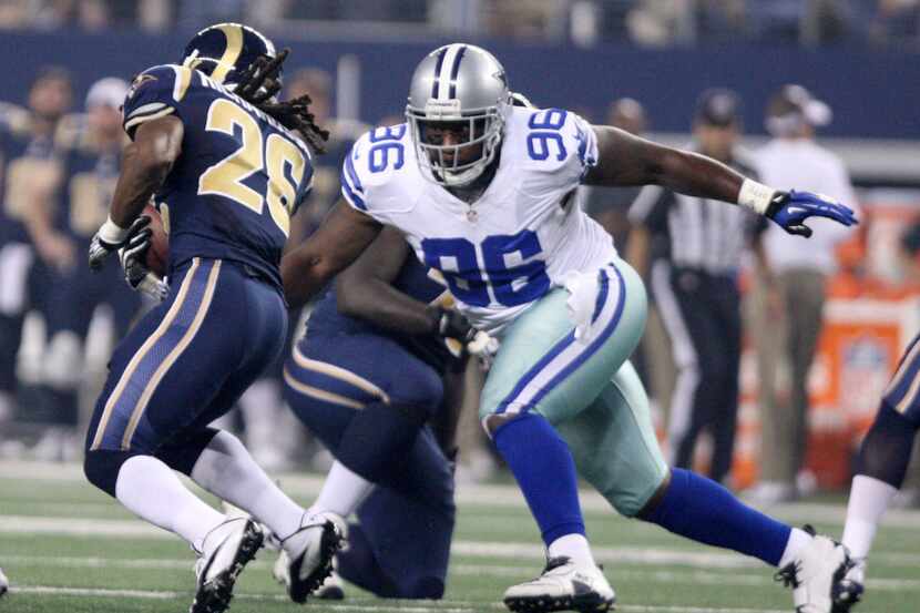 Cowboys defensive tackle Marcus Spears (96) takes down Rams running back Daryl Richardson...